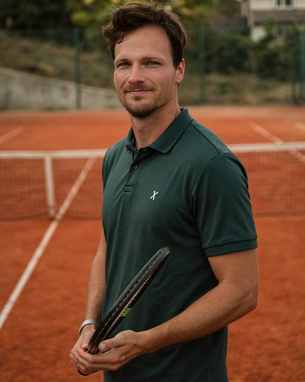 Timo Grützediek mit Tennisschläger auf einem Sandplatz (KI-generiertes Porträt)